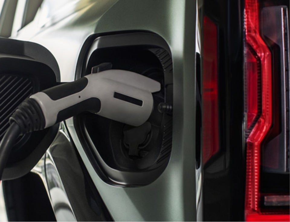 Close up of charging port with charger plugged in on a GMC Hummer EV SUV - Shaffer GMC in Kingwood WV